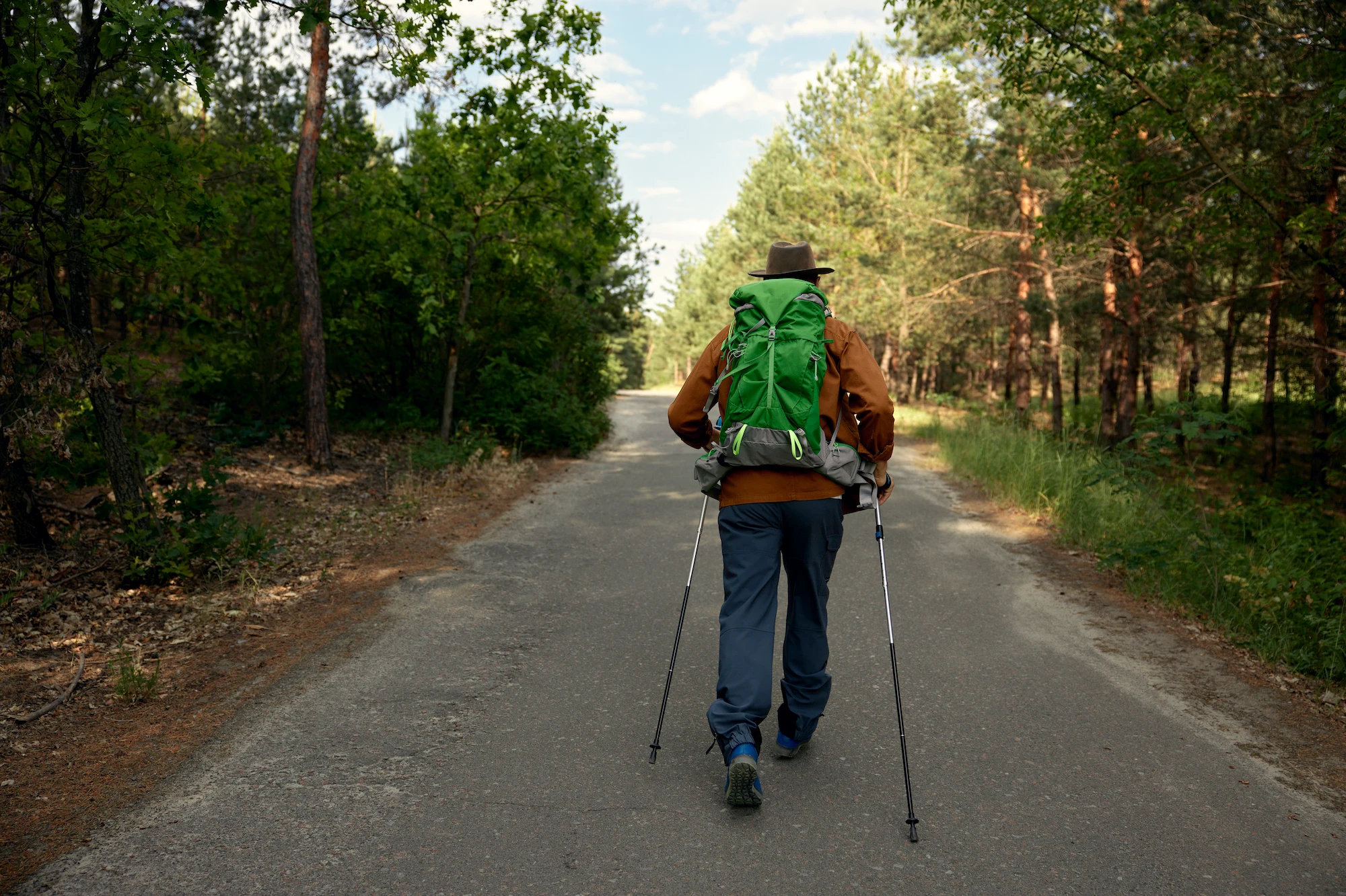 senior mature man training nordic walking in park